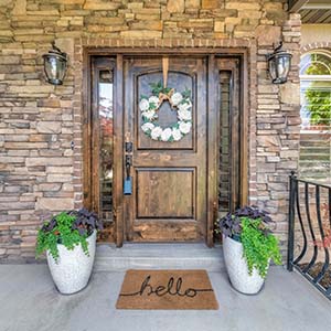 Roofs Fast Door Services - click to view door installation services and types of doors; view of stained wooden front door with wreath