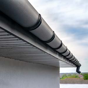 Roofs Fast Gutter Services - click to view services, styles, and colors; black seamless gutters close up